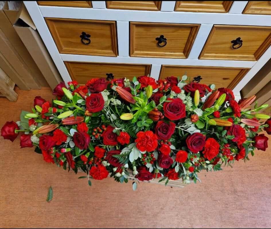Funeral flowers with lilies and roses